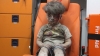 Horrors of war-ravaged Syria are exposed by image of wounded boy sitting alone in an ambulance