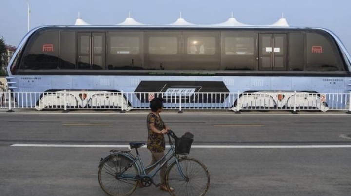 China's futuristic 'straddling bus' hits the road