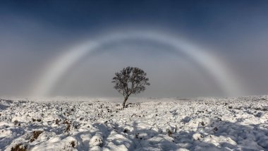 Amazing white rainbow snapped over Scottish moor