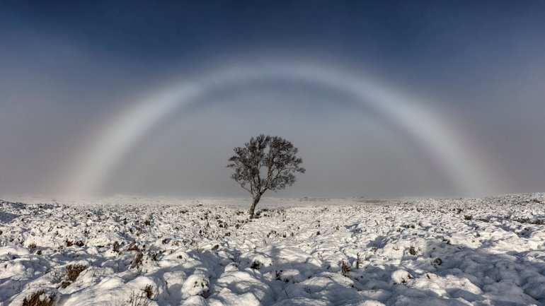 Amazing white rainbow snapped over Scottish moor