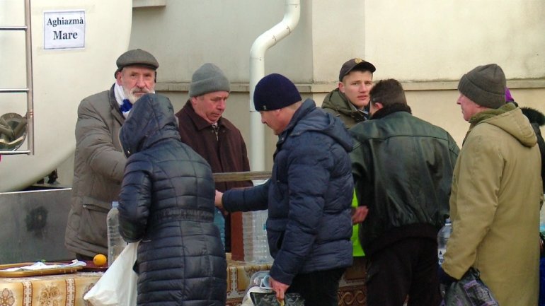 Doing business. Moldovans are selling holy water near church