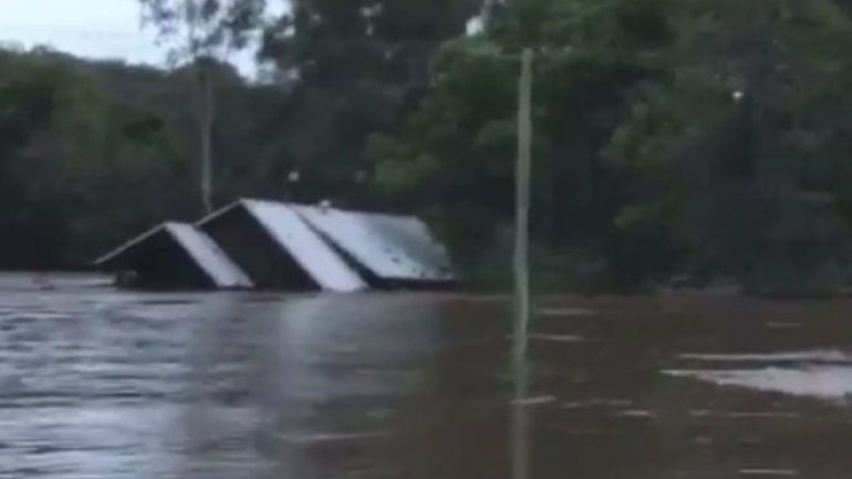 Australia floods: House washed away after family's rescue 