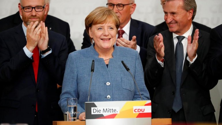 Merkel gets a fourth term but German voters deliver far-right surge