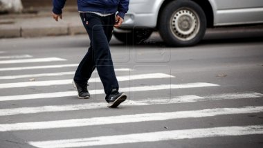 Young man hit by a minibus while crossing the street on the crosswalk