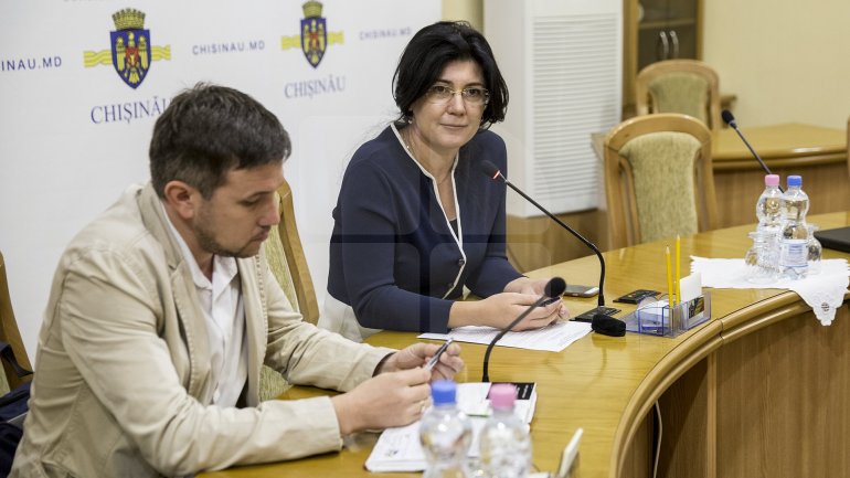 Silvia Radu cleans up City Hall. She requests councilmen to stop being late for work