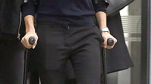 Exclusive photos of Victoria Beckham hobbles on crutches and a foot brace after mystery injury  