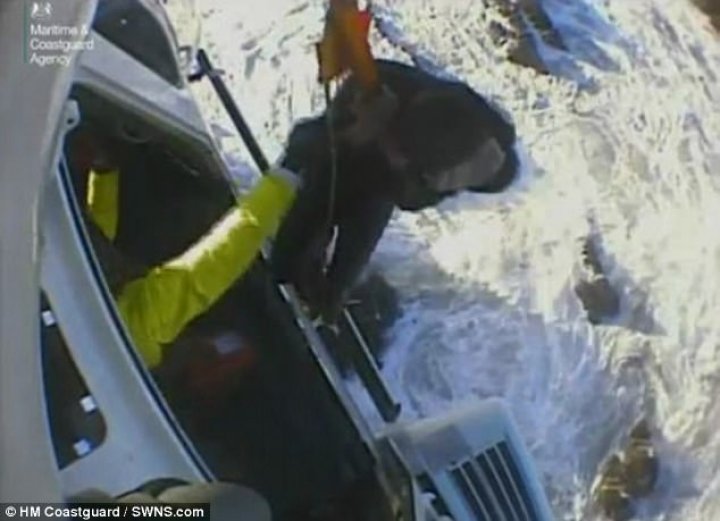 Two young men clinging to rocks were plucked to safety from sea by helicopter