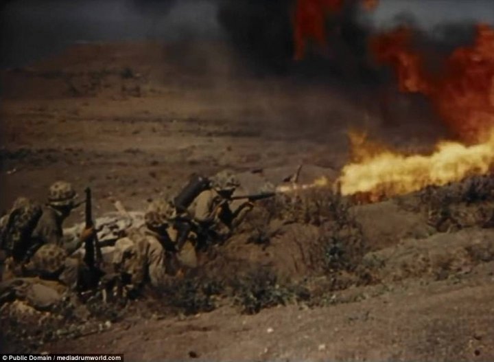 Incredible footage shows US Marines storming beaches at Iwo Jima and raiding bunkers with flamethrowers before hoisting the Stars and Stripes