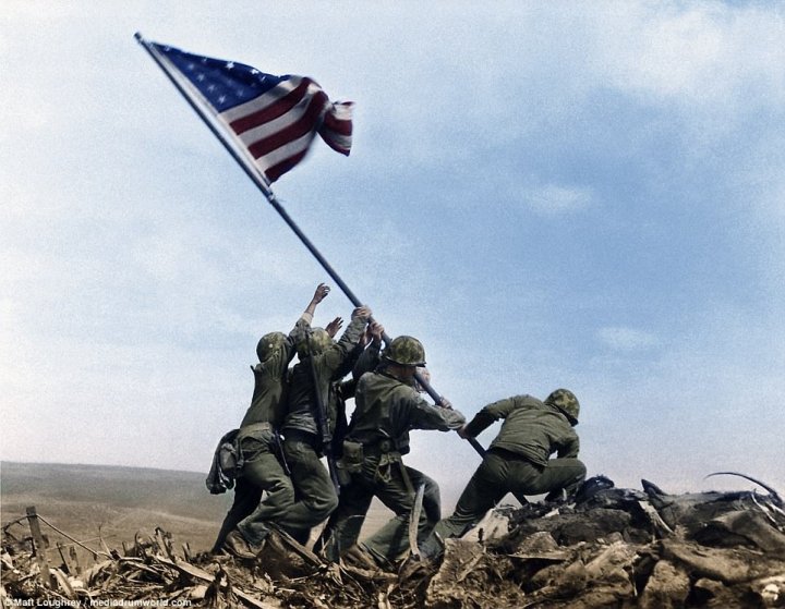 Incredible footage shows US Marines storming beaches at Iwo Jima and raiding bunkers with flamethrowers before hoisting the Stars and Stripes