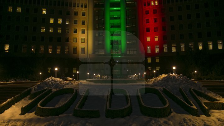 Lights spectacle in the square of Moldovan Parliament. Building was illuminated in Lithuanian flag colors