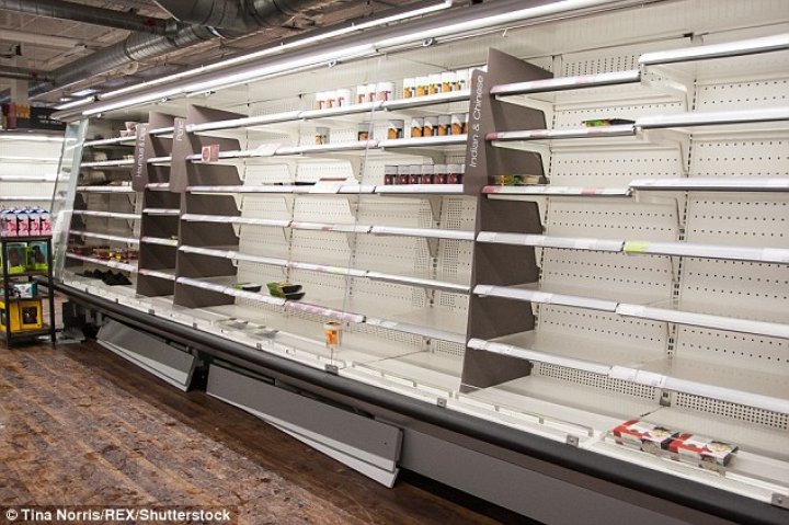 Supermarket shelves have been left bare as shoppers panic-buy essentials including milk and bread