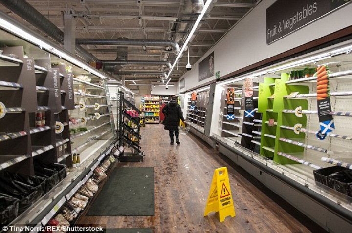 Supermarket shelves have been left bare as shoppers panic-buy essentials including milk and bread