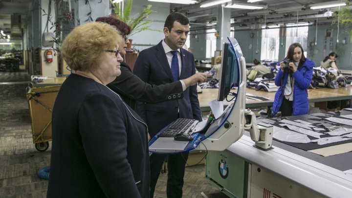 Chiril Gaburici visits Moldova's oldest clothing factory and hands female employees flowers