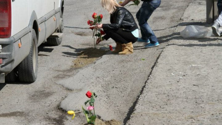 Young people plant flowers in potholes to grab authority attention  