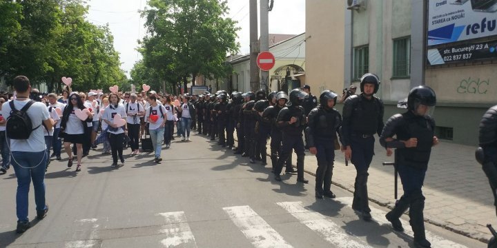 LGBT rally through Chisinau. Aggressive anti-march people controlled by force 