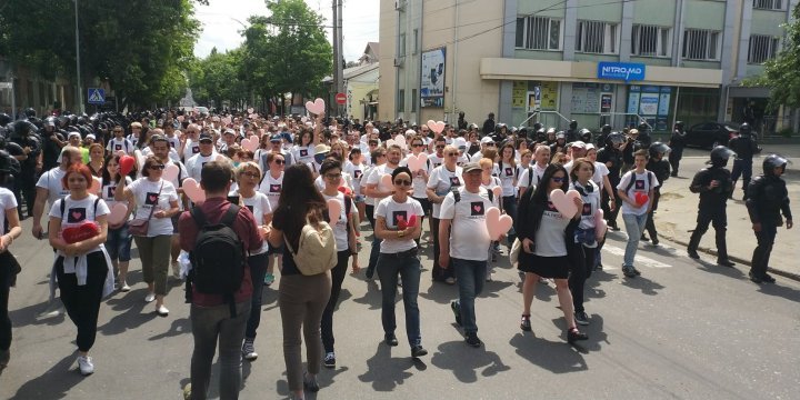 LGBT rally through Chisinau. Aggressive anti-march people controlled by force 