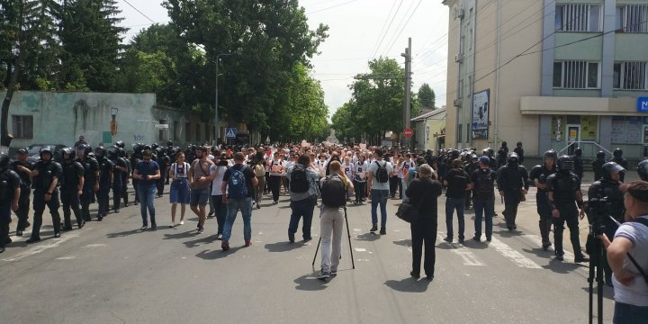 LGBT rally through Chisinau. Aggressive anti-march people controlled by force 