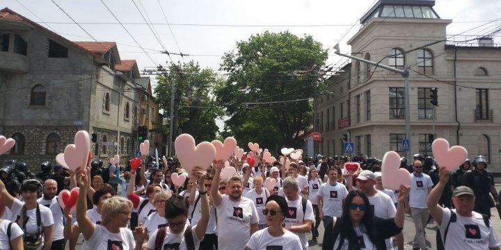 LGBT rally through Chisinau. Aggressive anti-march people controlled by force 