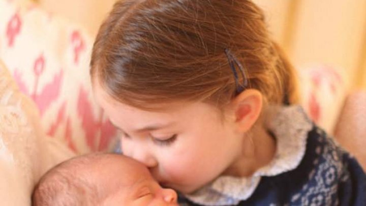 First photos of prince Louis ehld in a loving embrace of his older sister