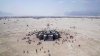 Fascinating drone footage taken above Burning Man shows stunning views of prominent installations at the arts and culture festival as thousands of revelers make their way around the desert by foot and bicycles