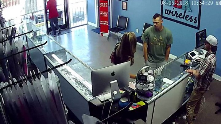 Shocking moment a couple's trip to a cellphone store turned into a violent affair when the boyfriend caught another man staring at his girlfriend's bottom