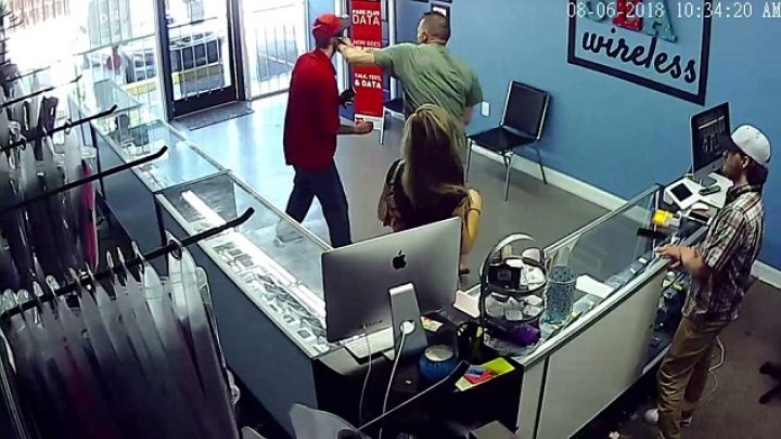 Shocking moment a couple's trip to a cellphone store turned into a violent affair when the boyfriend caught another man staring at his girlfriend's bottom