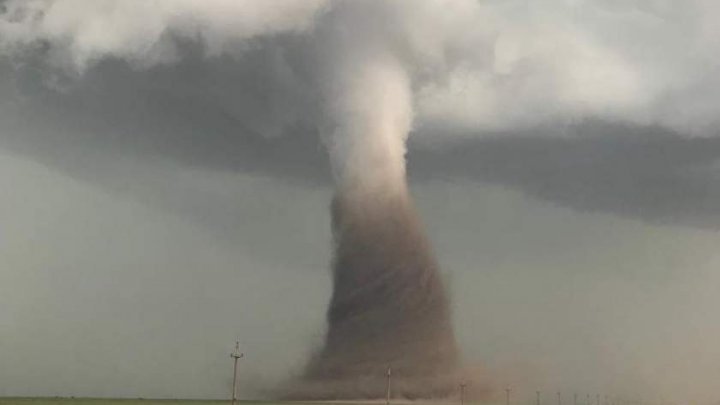 Thrilling video filmed by drivers of huge tornado that has struck Romania 