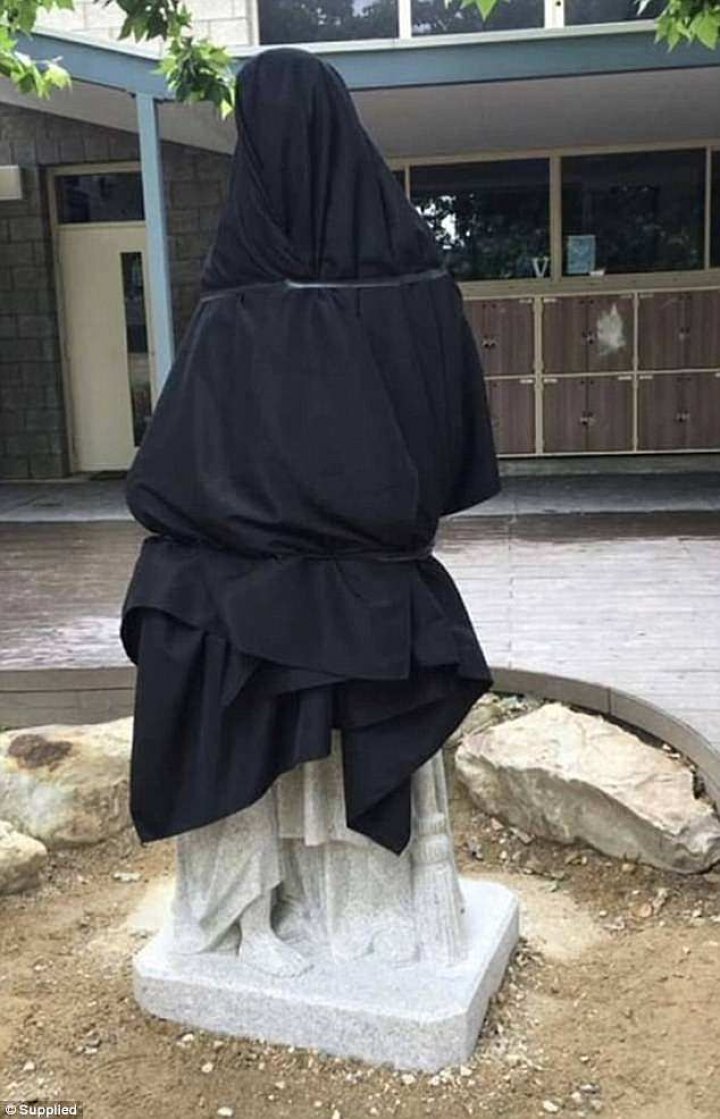 Catholic school forced to remove a an uncomfortable statue of a monk feeding boy a loaf (PHOTOS)