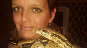 Indiana woman found dead with 8ft python wrapped around her neck in house filled with 140 snakes