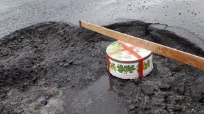 Не ждут милости от властей: жители Кишинева заделывают ямы на дорогах чем могут 